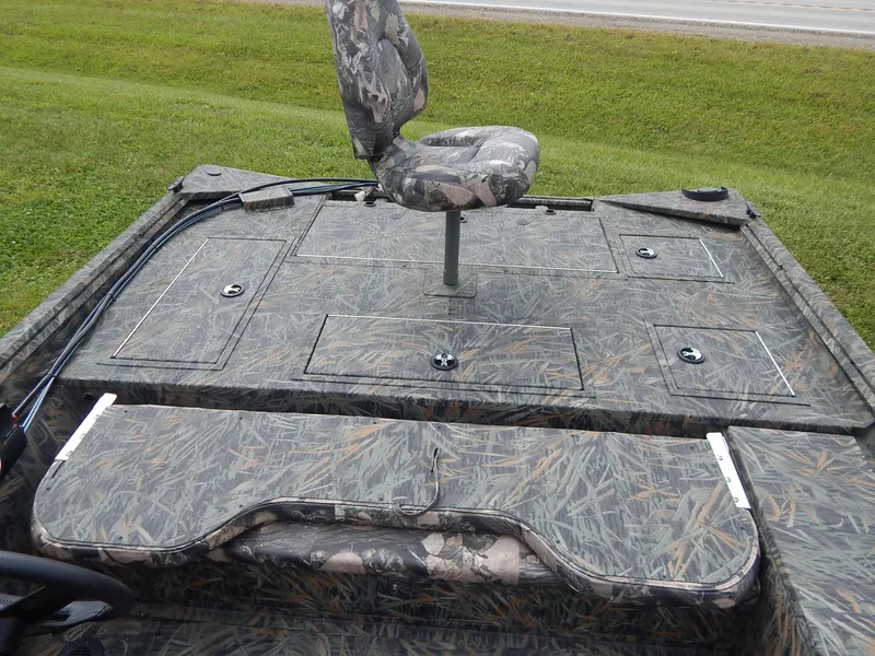 Slide: The Image of 2024 Polar Kraft SPORT X 190 CC boat with camo seating and storage compartments. - 12