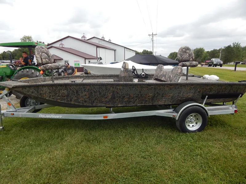 Slide: The Image of 2024 Polar Kraft SPORT X 190 CC boat on a trailer, camo design, outdoor display. - 6