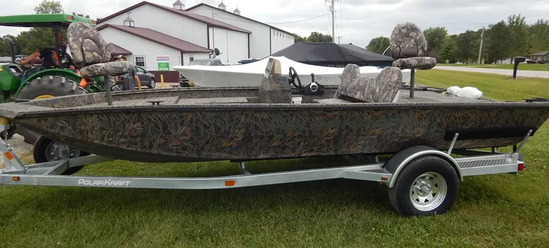 Slide: The Image of 2024 Polar Kraft SPORT X 190 CC boat on a trailer, camo design, outdoor display. - 7