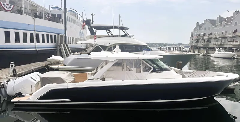 Slide: The Image of 2024 Tiara Yachts 43 LS docked in a marina, side view. - 0