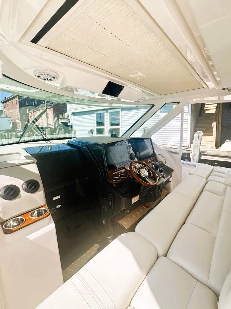 Slide: The Image of 2024 Tiara Yachts 43 LS interior with luxurious seating and modern helm design. - 30