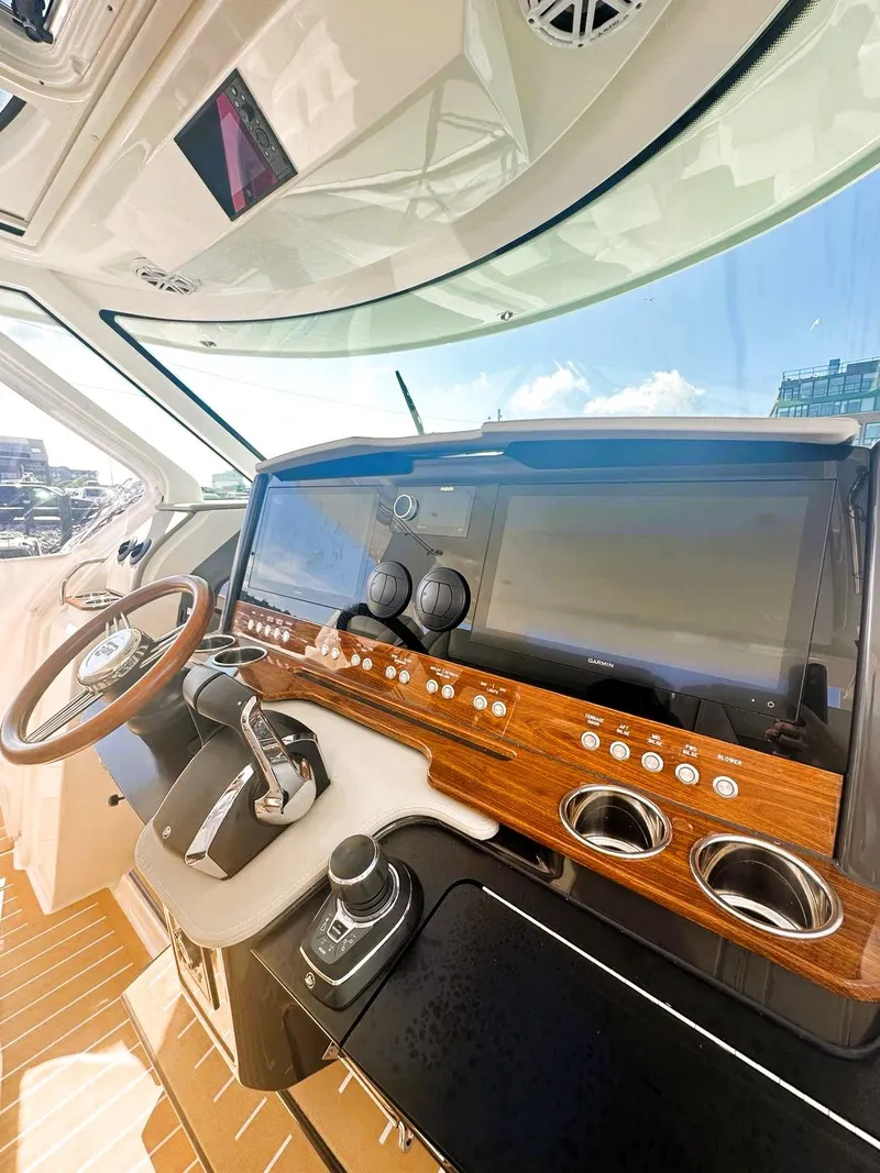 Slide: The Image of 2024 Tiara Yachts 43 LS helm with modern controls and sleek design. - 31