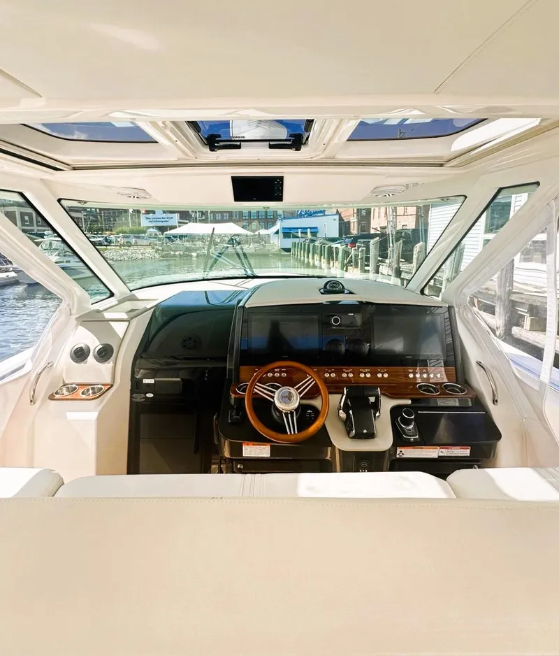 Slide: The Image of 2024 Tiara Yachts 43 LS helm with modern controls and panoramic windows. - 34