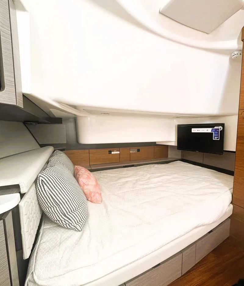 Slide: The Image of 2024 Tiara Yachts 43 LS cabin interior with cozy bed and modern design. - 36