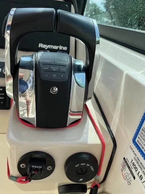 Slide: The Image of 2018 Boston Whaler 270 Vantage throttle controls and Raymarine electronics. - 11