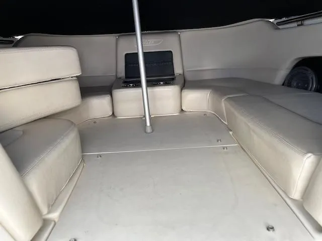 Slide: The Image of 2018 Boston Whaler 270 Vantage boat interior with beige seating and storage compartments. - 19