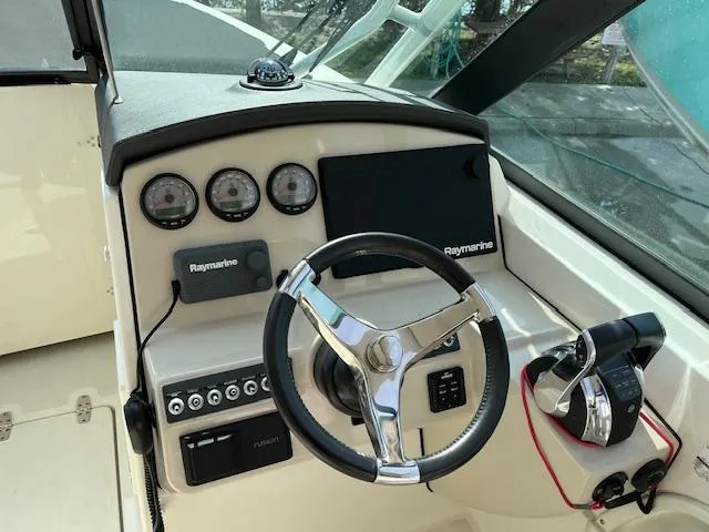 Slide: The Image of 2018 Boston Whaler 270 Vantage boat helm with Raymarine electronics and steering wheel. - 24
