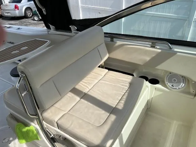 Slide: The Image of 2018 Boston Whaler 270 Vantage boat interior with white cushioned seating and cup holders. - 27