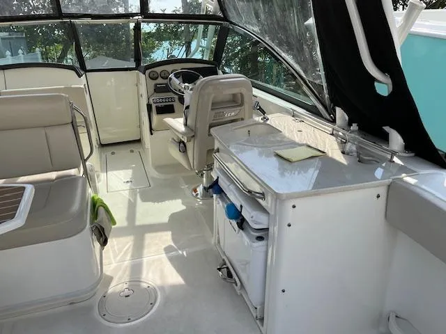 Slide: The Image of 2018 Boston Whaler 270 Vantage boat interior with helm, seating, and storage. - 29