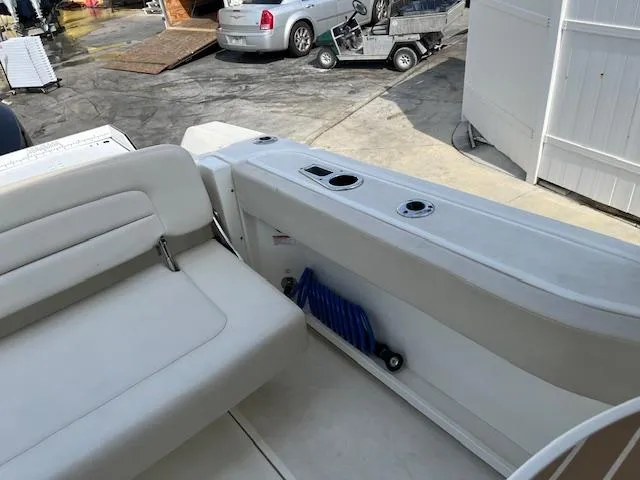 Slide: The Image of 2018 Boston Whaler 270 Vantage boat interior with white seating and storage compartment. - 32