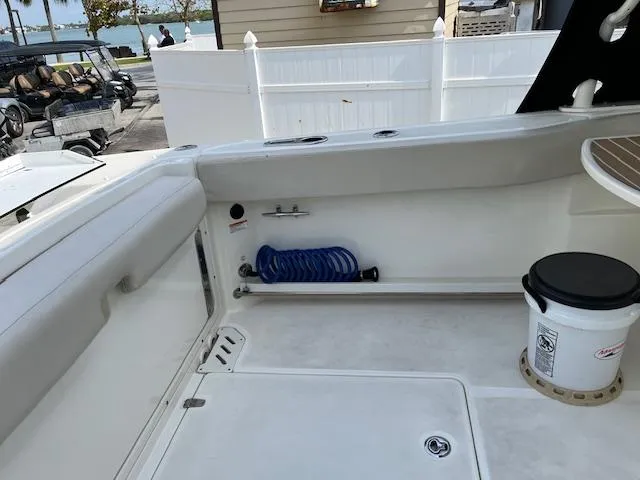 Slide: The Image of 2018 Boston Whaler 270 Vantage boat interior with storage and coiled hose. - 35