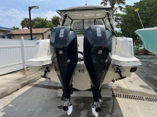Slide: The Image of 2018 Boston Whaler 270 Vantage with twin outboard engines docked. - 38