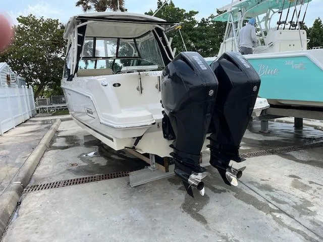 Slide: The Image of 2018 Boston Whaler 270 Vantage with twin outboard engines on a trailer. - 39