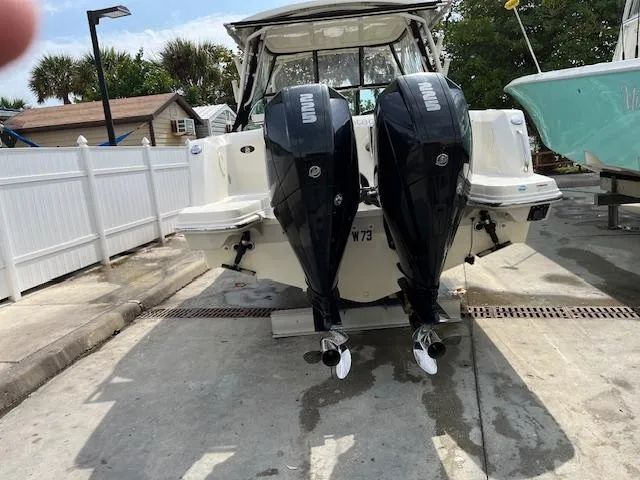 Slide: The Image of 2018 Boston Whaler 270 Vantage with dual outboard engines at a dock. - 40