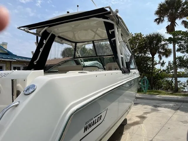 Slide: The Image of 2018 Boston Whaler 270 Vantage boat docked near palm trees. - 43
