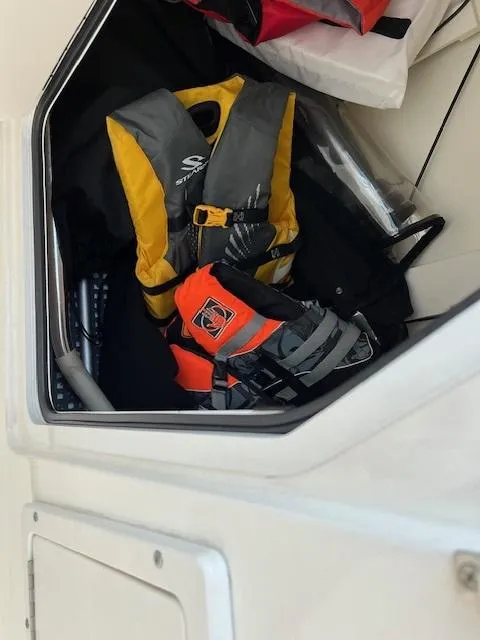 Slide: The Image of Life jackets stored in a compartment on a 2018 Boston Whaler 270 Vantage boat. - 44