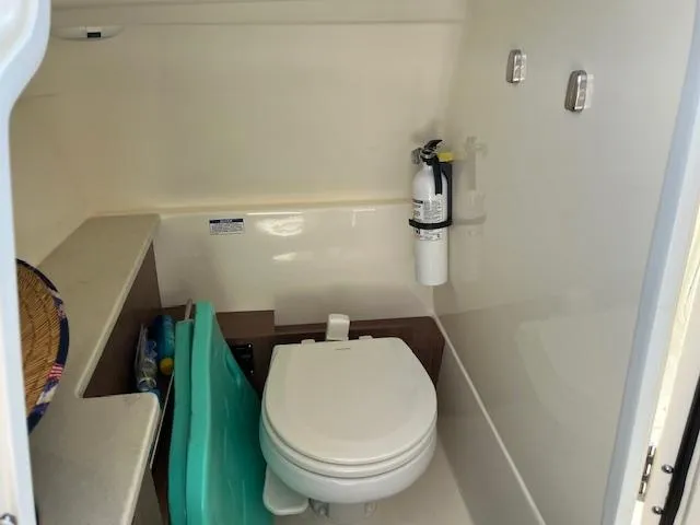 Slide: The Image of 2018 Boston Whaler 270 Vantage boat interior bathroom with toilet and fire extinguisher. - 45