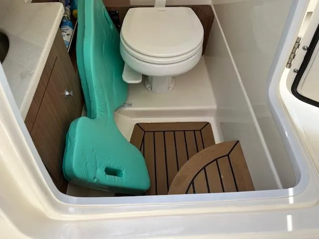 Slide: The Image of 2018 Boston Whaler 270 Vantage boat bathroom with toilet and storage. - 46