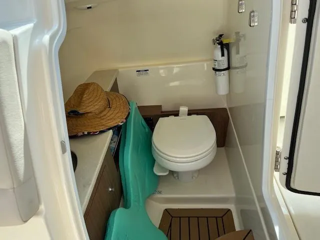 Slide: The Image of 2018 Boston Whaler 270 Vantage boat interior with toilet and storage area. - 48
