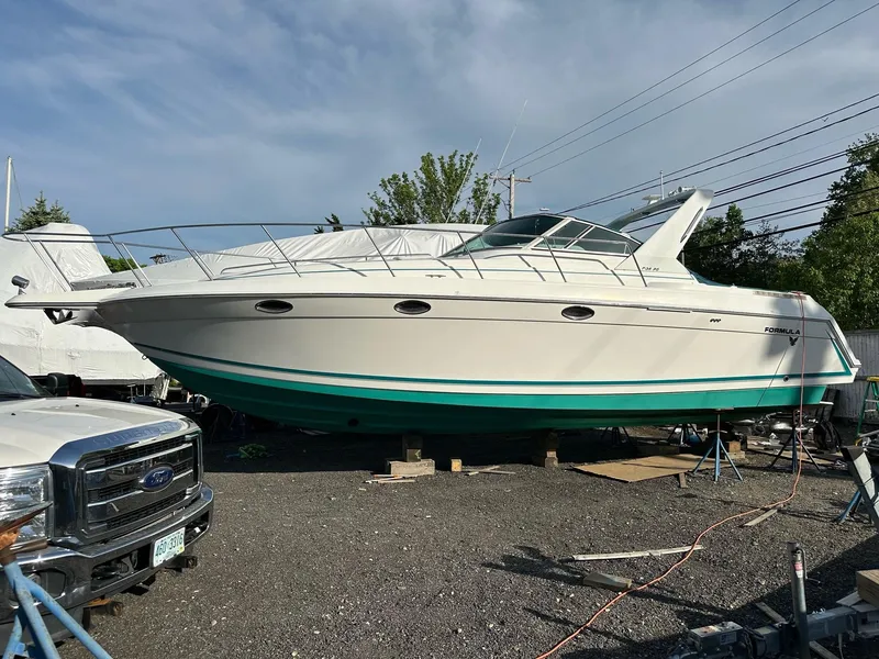 Slide: The Image of 1997 Formula 34 PC boat docked, featuring "Plan Sea" name, Newburyport, MA. - 1