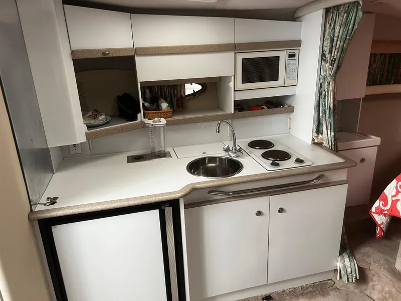 Slide: The Image of Flat-screen TV mounted on a wall inside a 1997 Formula 34 PC boat. - 10