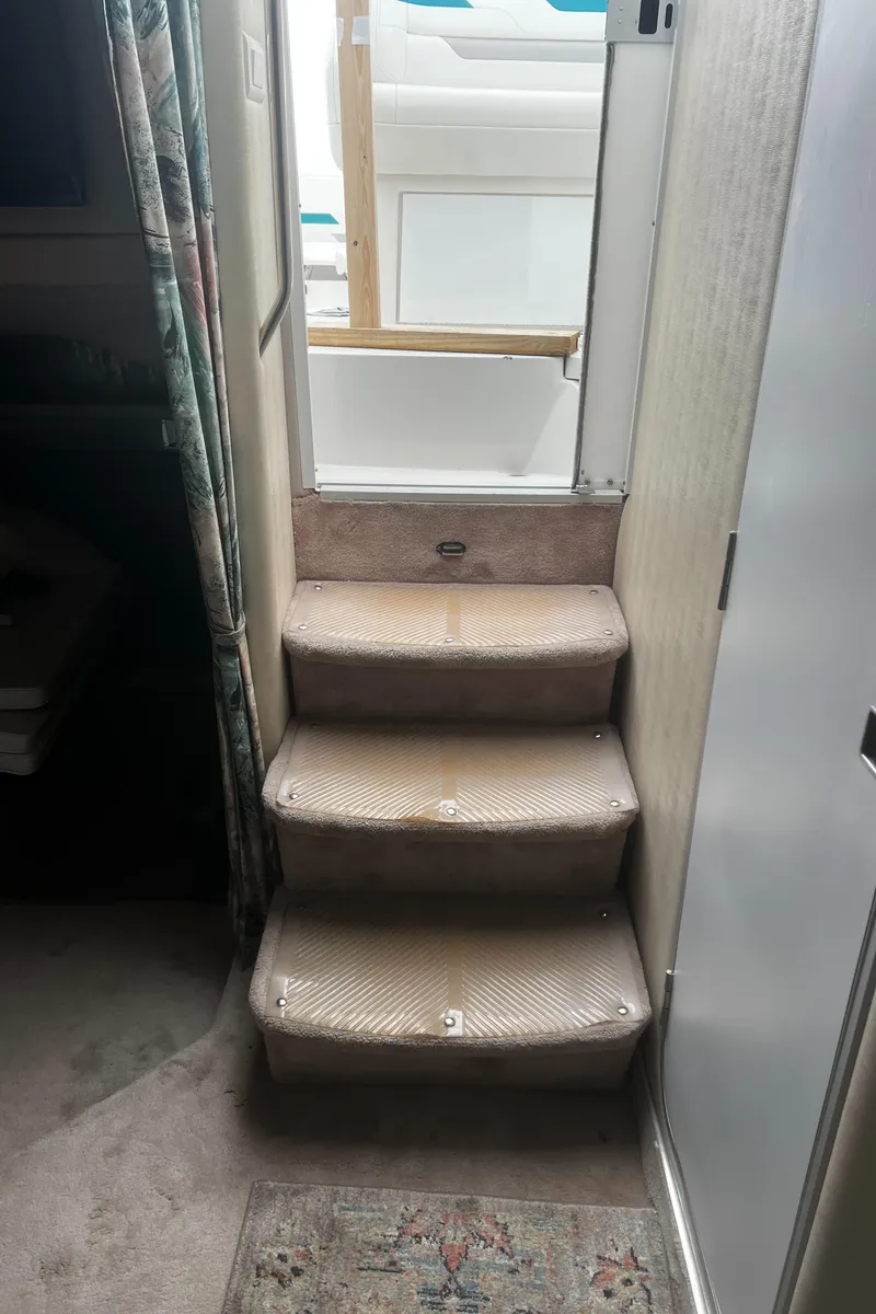 Slide: The Image of 1997 Formula 34 PC cabin interior with kitchen, bed, and seating area. - 12