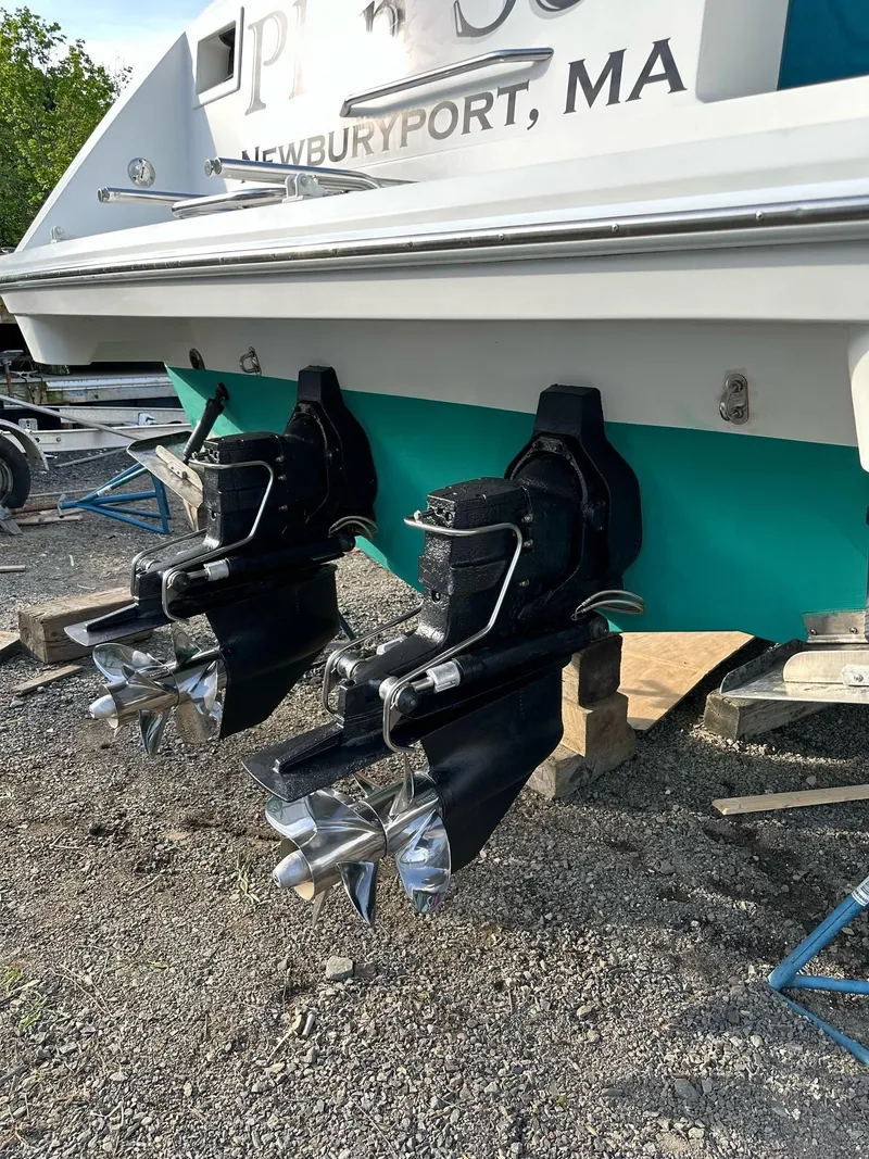 Slide: The Image of 1997 Formula 34 PC boat docked, featuring sleek design and teal canopy. - 2