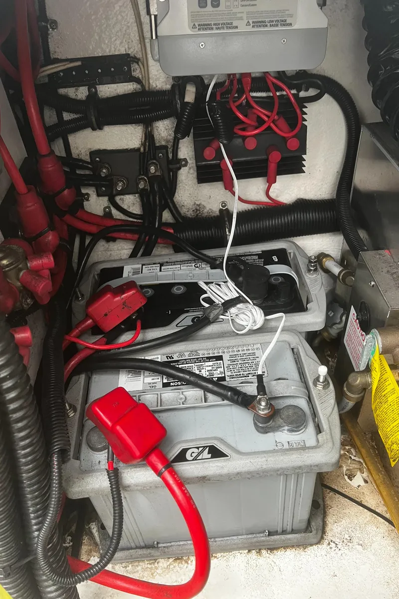 Slide: The Image of Battery compartment of a 1997 Formula 34 PC boat with wiring and connections. - 25