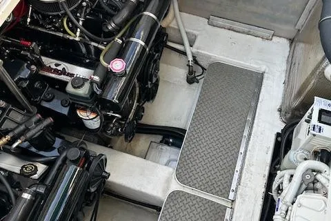 Slide: The Image of Engine compartment of a 1997 Formula 34 PC boat, showcasing mechanical components and textured flooring. - 29