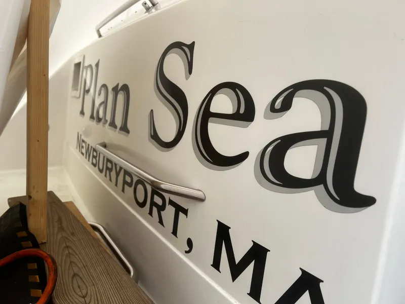 Slide: The Image of 1997 Formula 34 PC boat being lifted by a crane at a marina. - 3