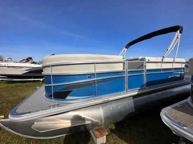 The Image of 2024 Starcraft LX 20 R pontoon boat with blue and white exterior. - 1