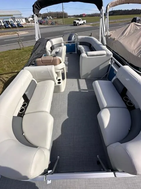 Slide: The Image of 2024 Starcraft LX 20 R pontoon boat with spacious seating and modern design. - 2
