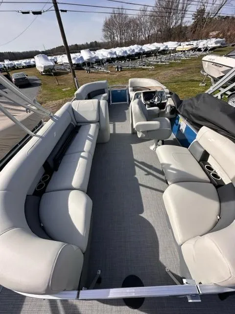 Slide: The Image of 2024 Starcraft LX 20 R pontoon boat with spacious seating and modern design. - 3