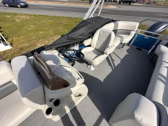 Slide: The Image of 2024 Starcraft LX 20 R pontoon boat interior with helm and seating. - 4