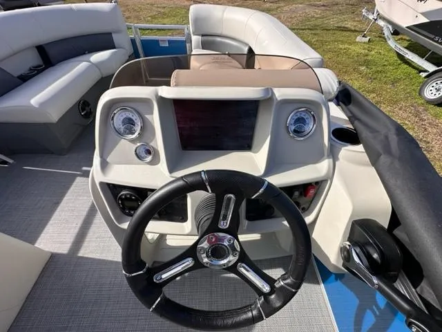 Slide: The Image of 2024 Starcraft LX 20 R boat dashboard with steering wheel and control panel. - 5