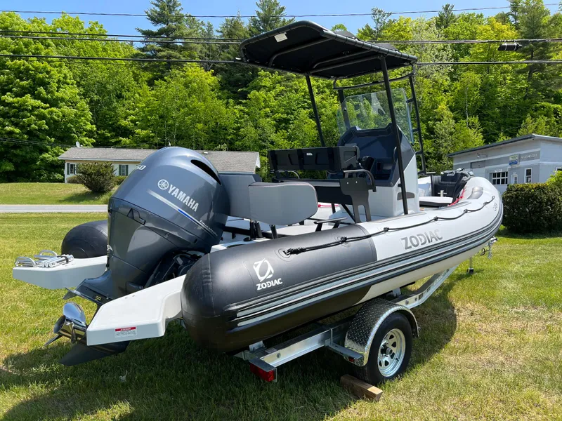 Slide: The Image of 2023 Zodiac Open 5.5 boat with Yamaha engine on trailer, parked on grass. - 3