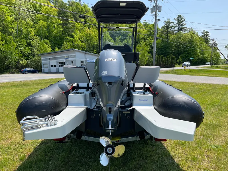 Slide: The Image of 2023 Zodiac Open 5.5 boat with 150 HP engine, rear view on grass. - 4