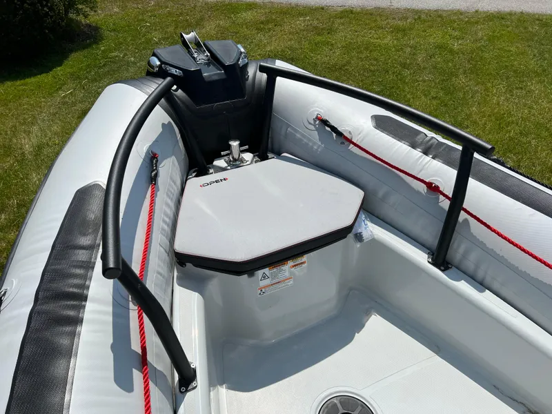 Slide: The Image of 2023 Zodiac Open 5.5 boat interior with seating and control console. - 9