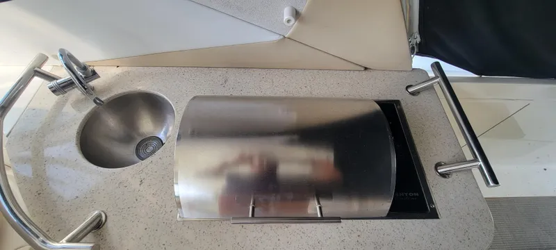 Slide: The Image of Sea Ray 350 Sundancer 2008 boat kitchenette with sink and covered stove. - 12