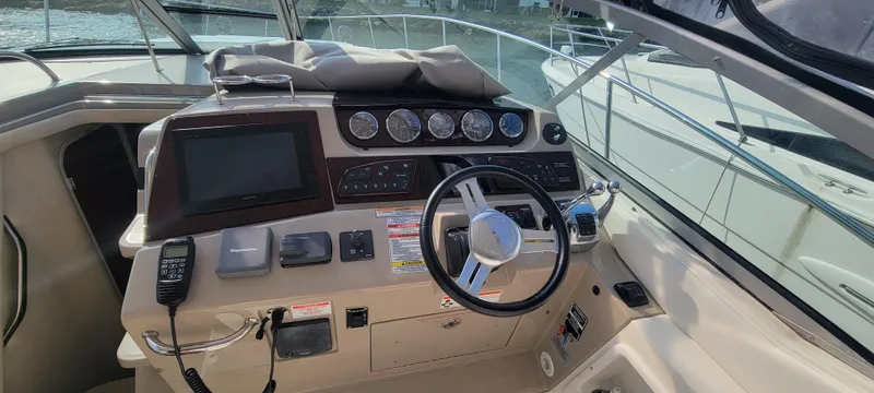 Slide: The Image of Helm of 2008 Sea Ray 350 Sundancer with steering wheel, gauges, and navigation equipment. - 16