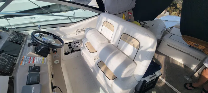 Slide: The Image of 2008 Sea Ray 350 Sundancer cockpit with white seating and steering wheel. - 20