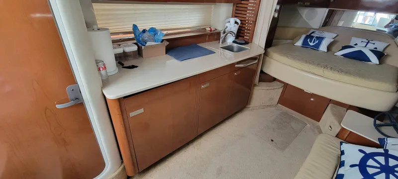 Slide: The Image of Interior of 2008 Sea Ray 350 Sundancer with kitchenette and cozy sleeping area. - 22