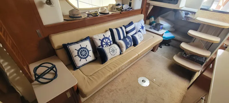 Slide: The Image of Interior of 2008 Sea Ray 350 Sundancer with nautical-themed decor and beige seating. - 24