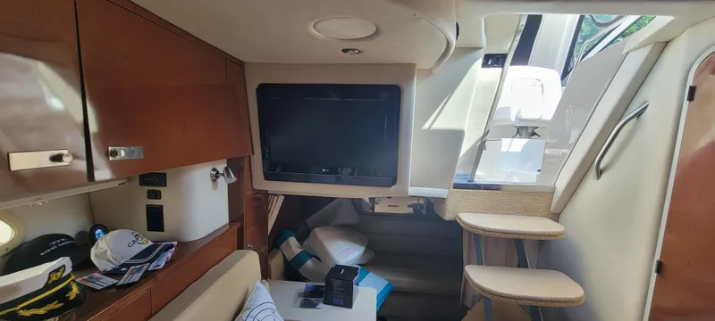 Slide: The Image of Interior cabin of a 2008 Sea Ray 350 Sundancer yacht with TV and seating. - 25
