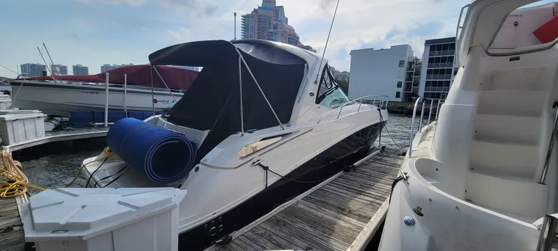 Slide: The Image of 2008 Sea Ray 350 Sundancer docked at marina with cityscape background. - 3