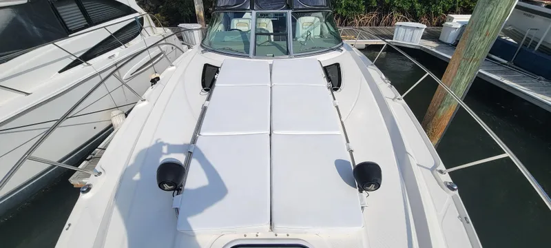 Slide: The Image of 2008 Sea Ray 350 Sundancer boat docked, featuring spacious sun pads on the bow. - 6