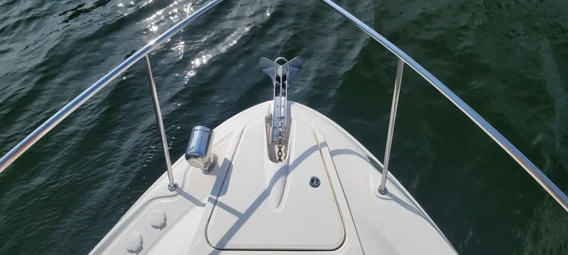 Slide: The Image of Bow of 2008 Sea Ray 350 Sundancer on water, featuring stainless steel railings. - 8