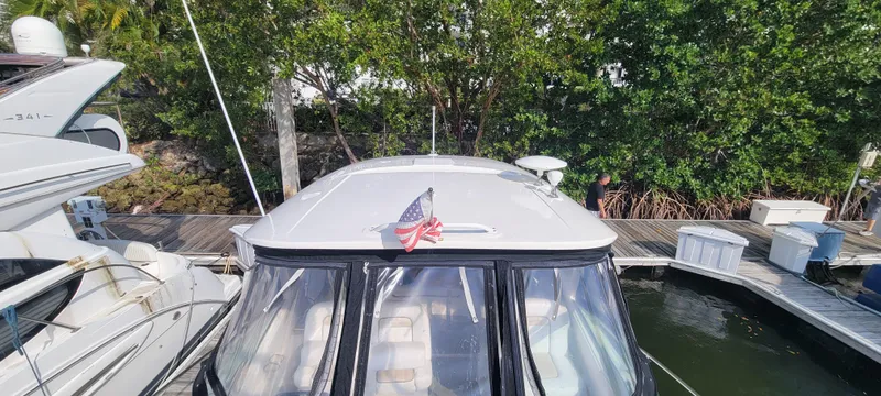 Slide: The Image of 2008 Sea Ray 350 Sundancer docked at a marina with an American flag. - 9