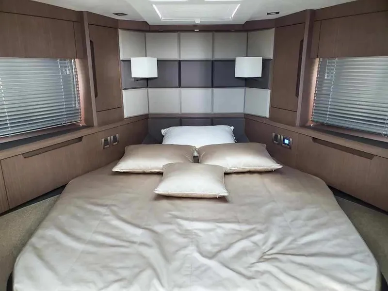 Slide: The Image of Luxurious bedroom in 2020 Galeon 500 Fly yacht with modern decor and ample natural light. - 11