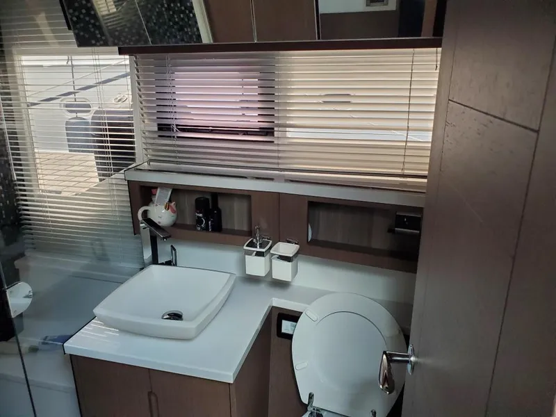 Slide: The Image of Modern bathroom interior of 2020 Galeon 500 Fly yacht with sink, toilet, and window blinds. - 16